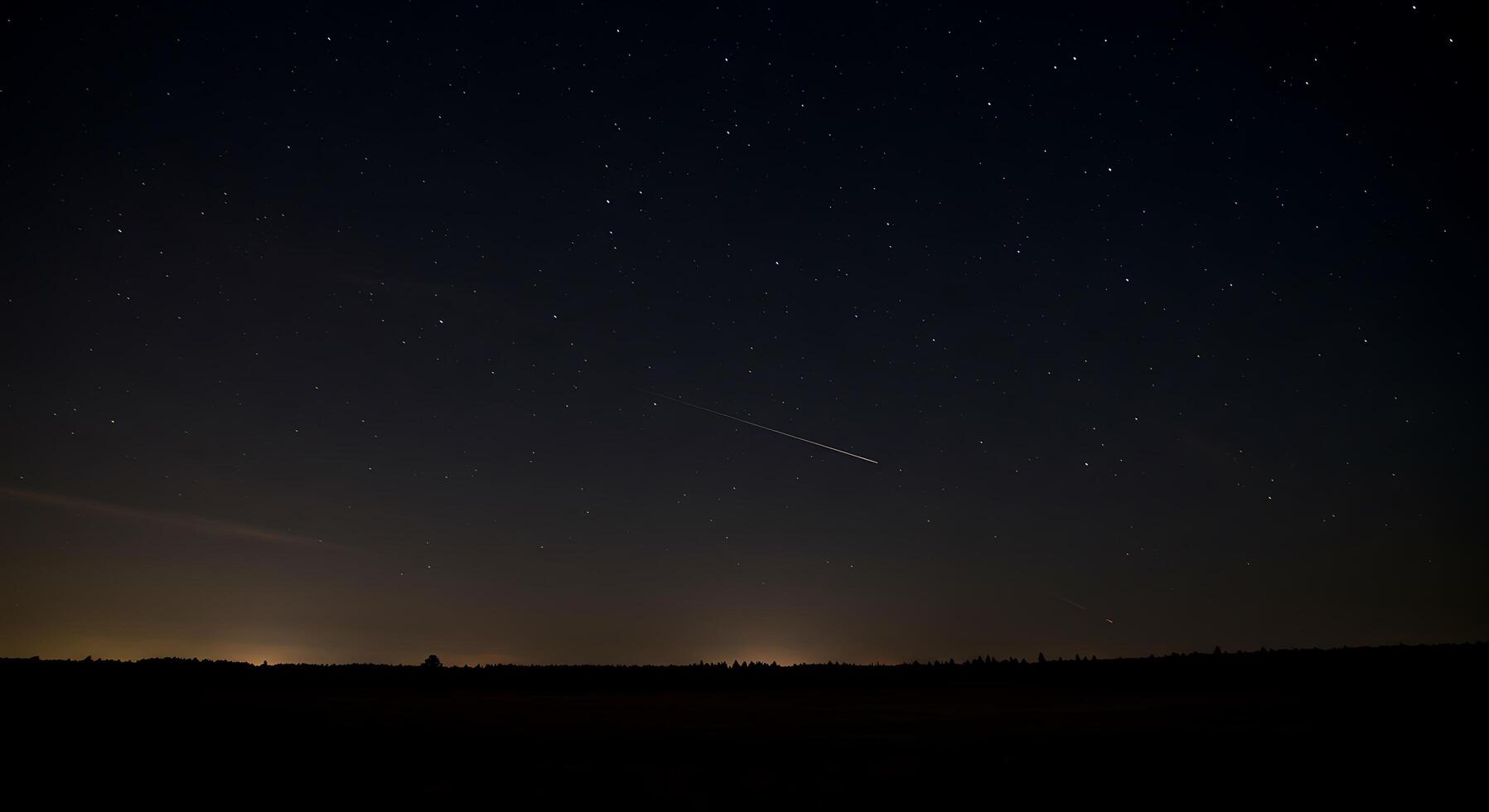 A night sky with a comet and a shooting star photo