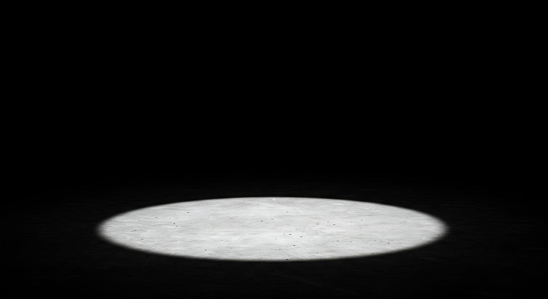 A white light shines on a black surface photo