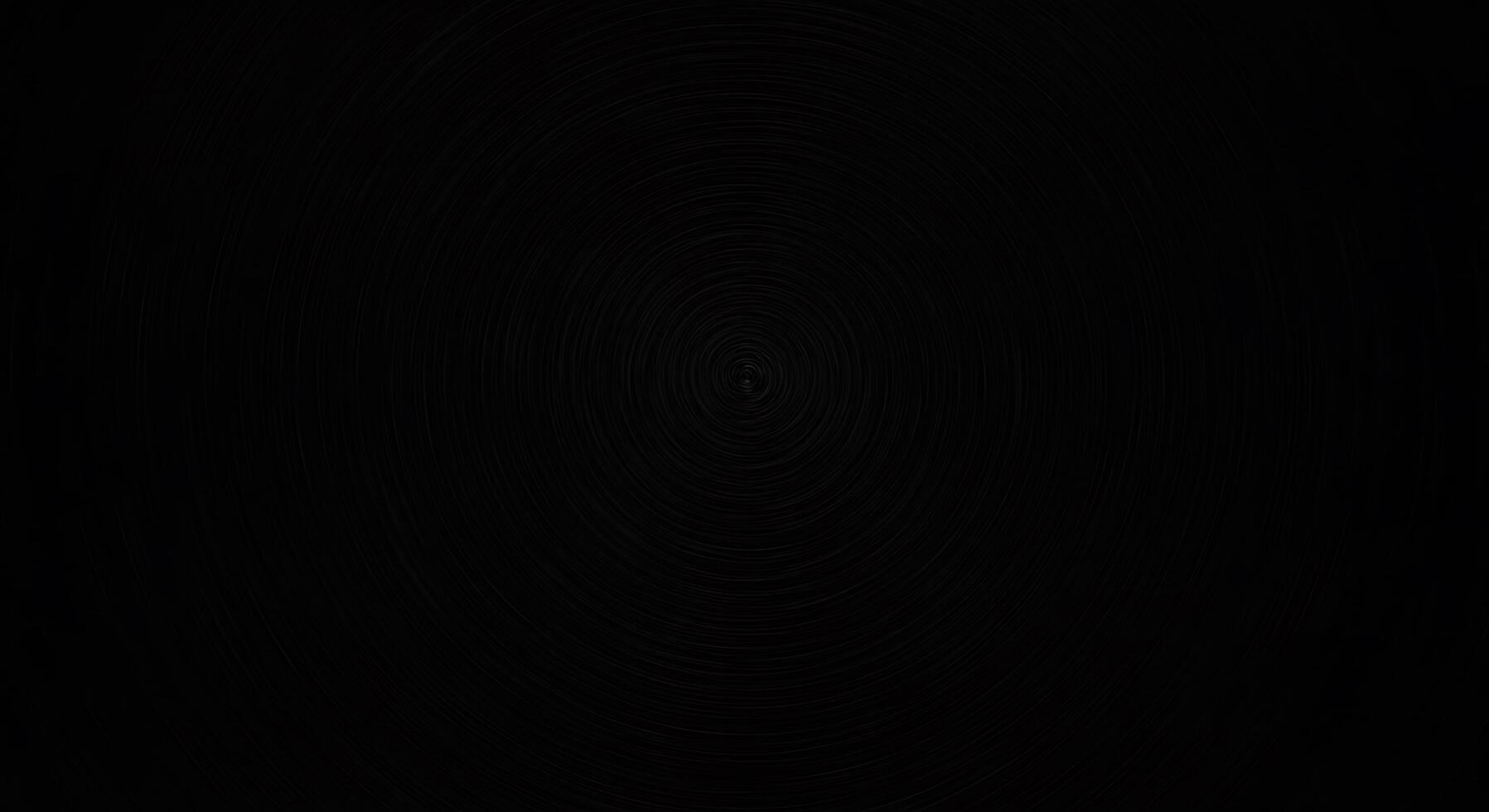 A black background with a circular pattern photo