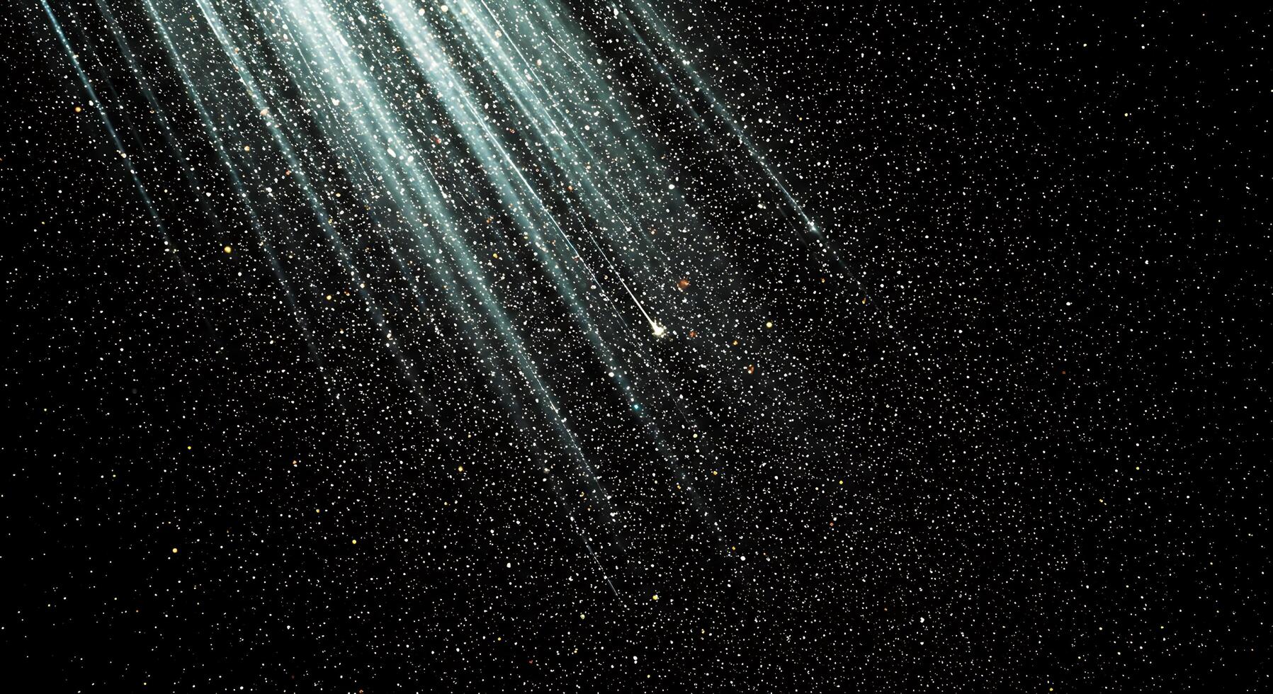 Comet is seen in the night sky with bright light beams photo