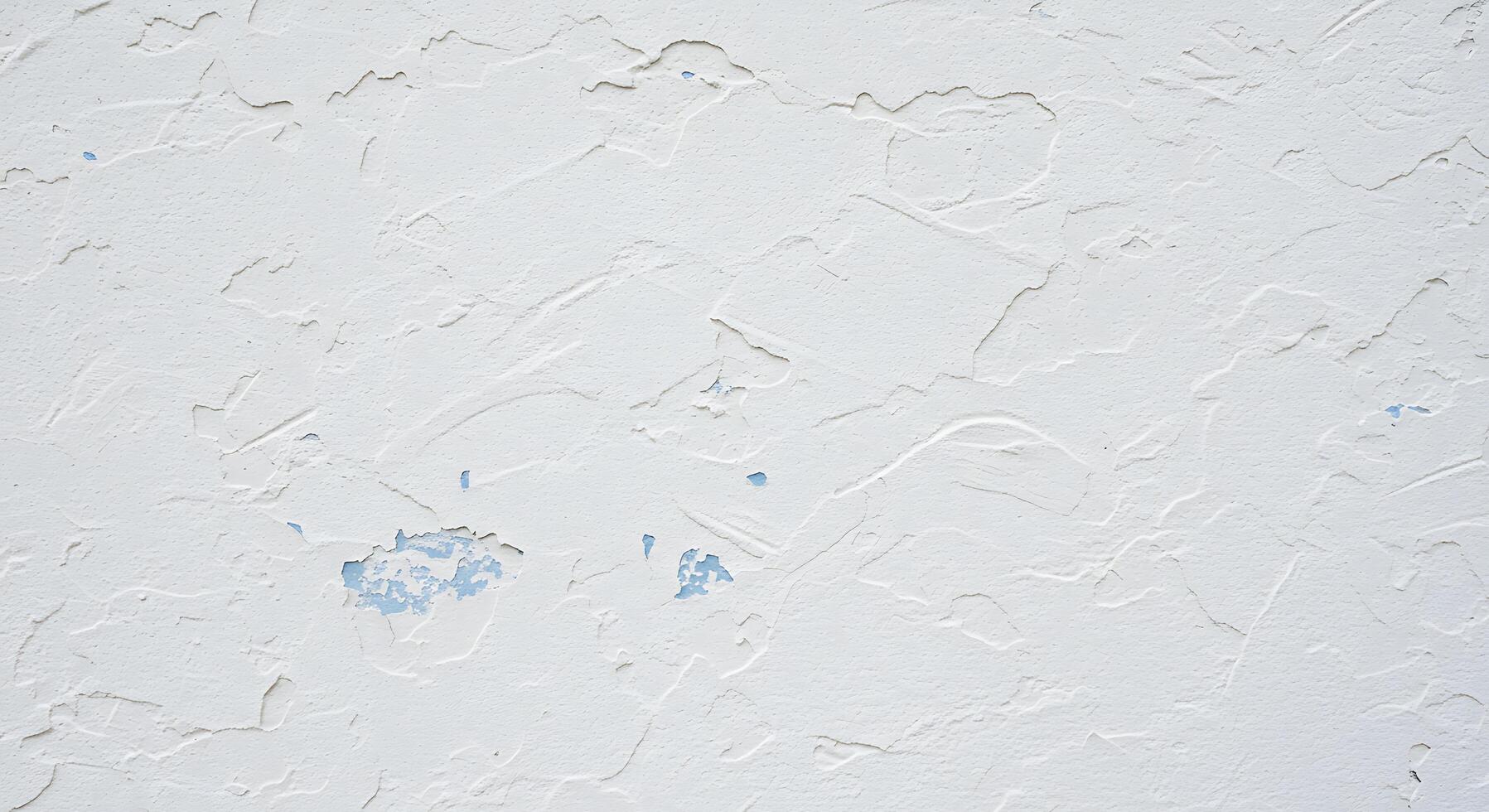 A white wall with paint peeling off of it photo