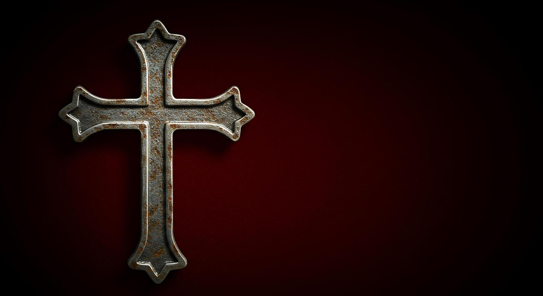 A rusty cross on a red background photo