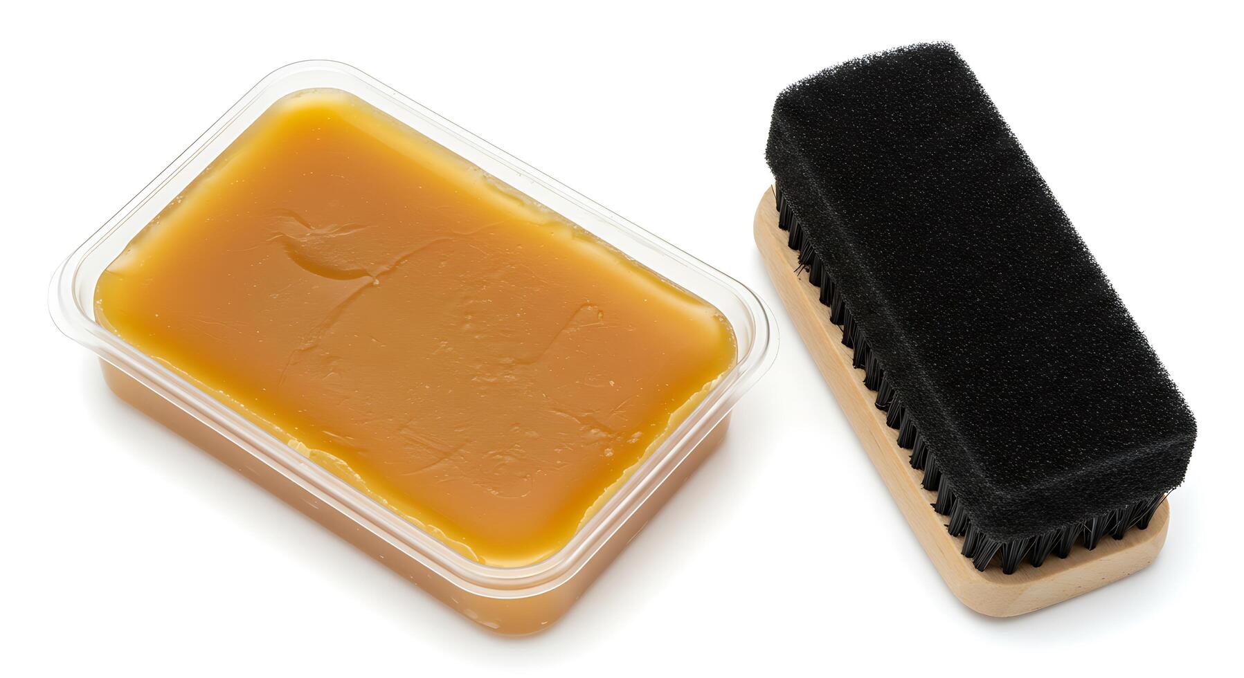 A brush and a container of yellow wax photo