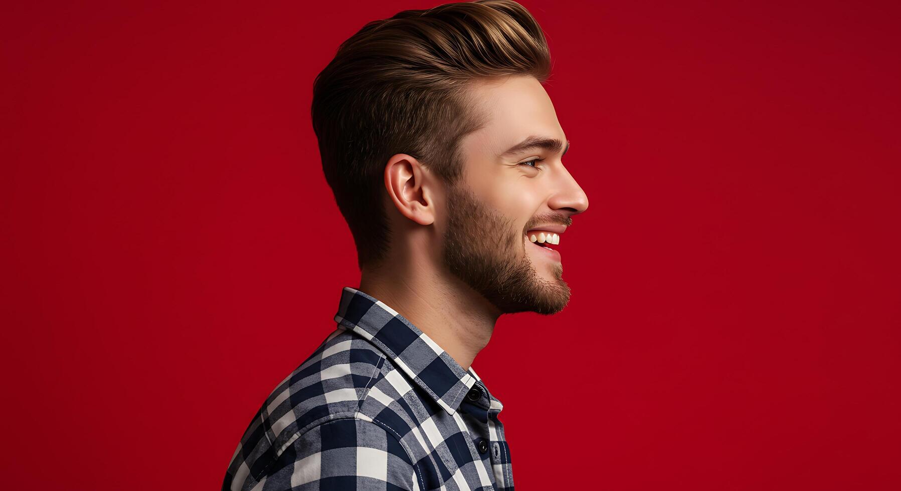 A man with a beard and checkered shirt smiling photo