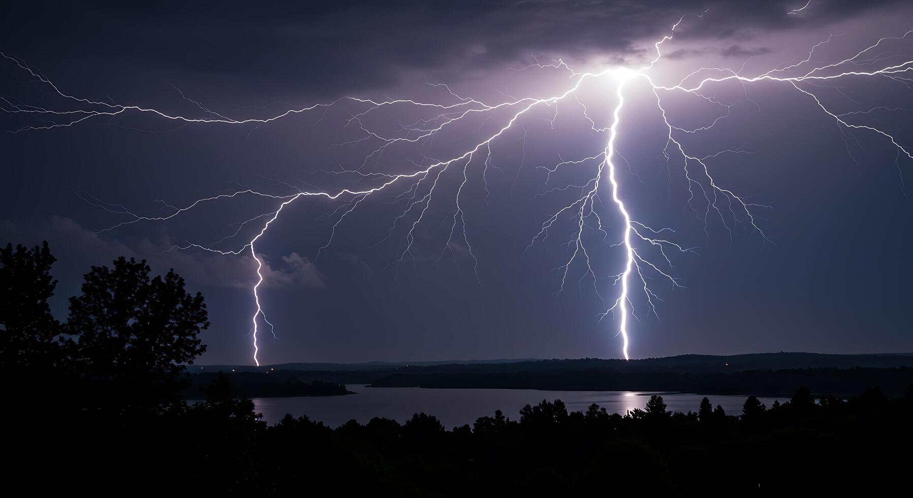 Lightning strikes over a lake and trees photo