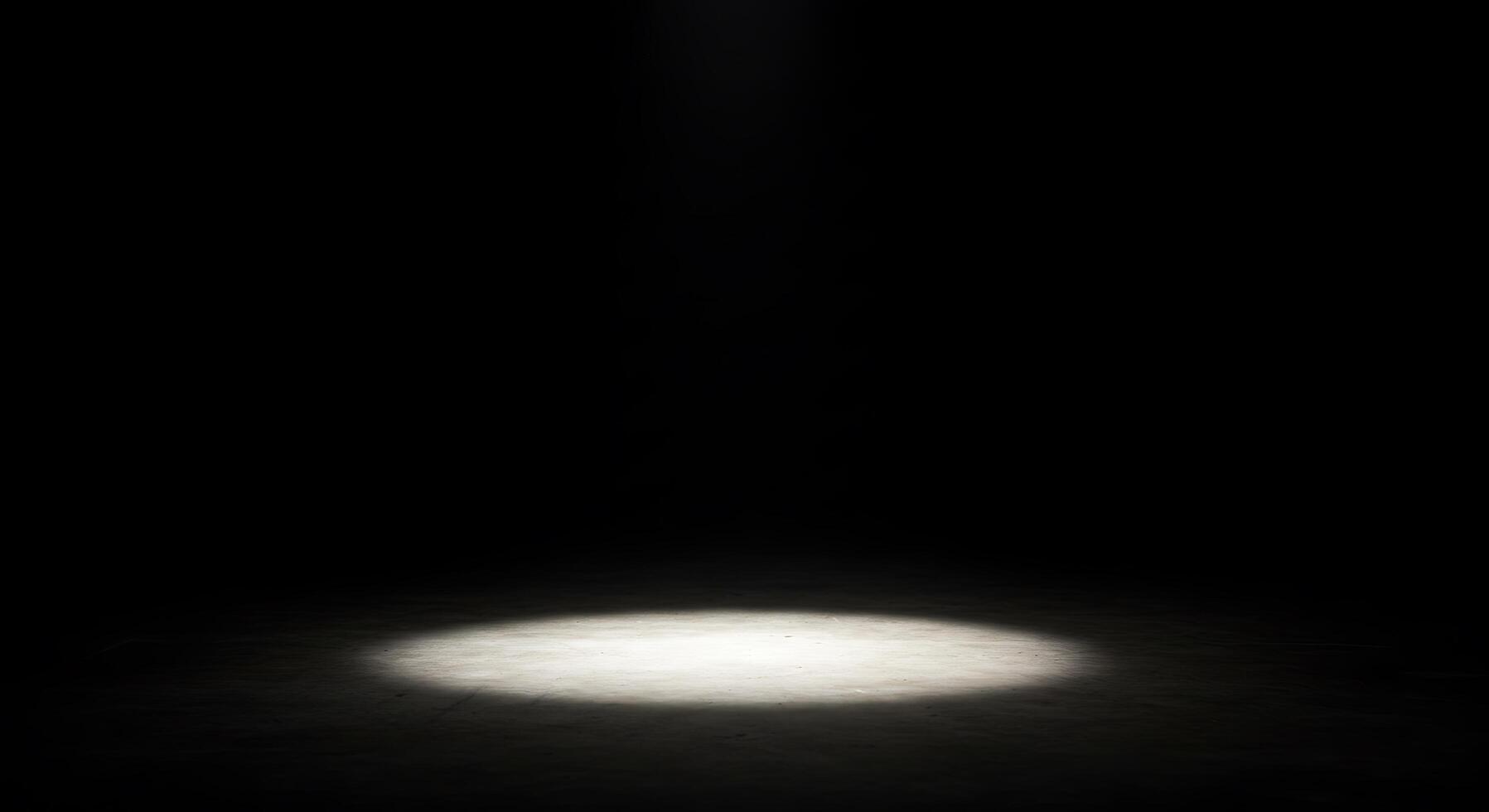 A spotlight shines on a dark floor photo
