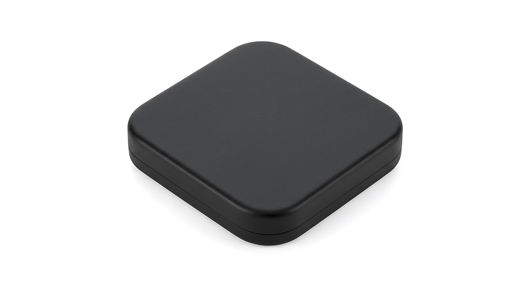 A black square shaped box sitting on top of a white surface photo