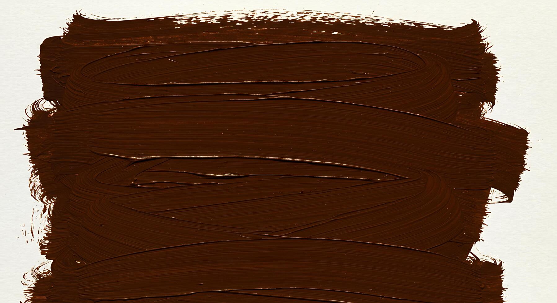A brown paint brush stroke on a white surface photo