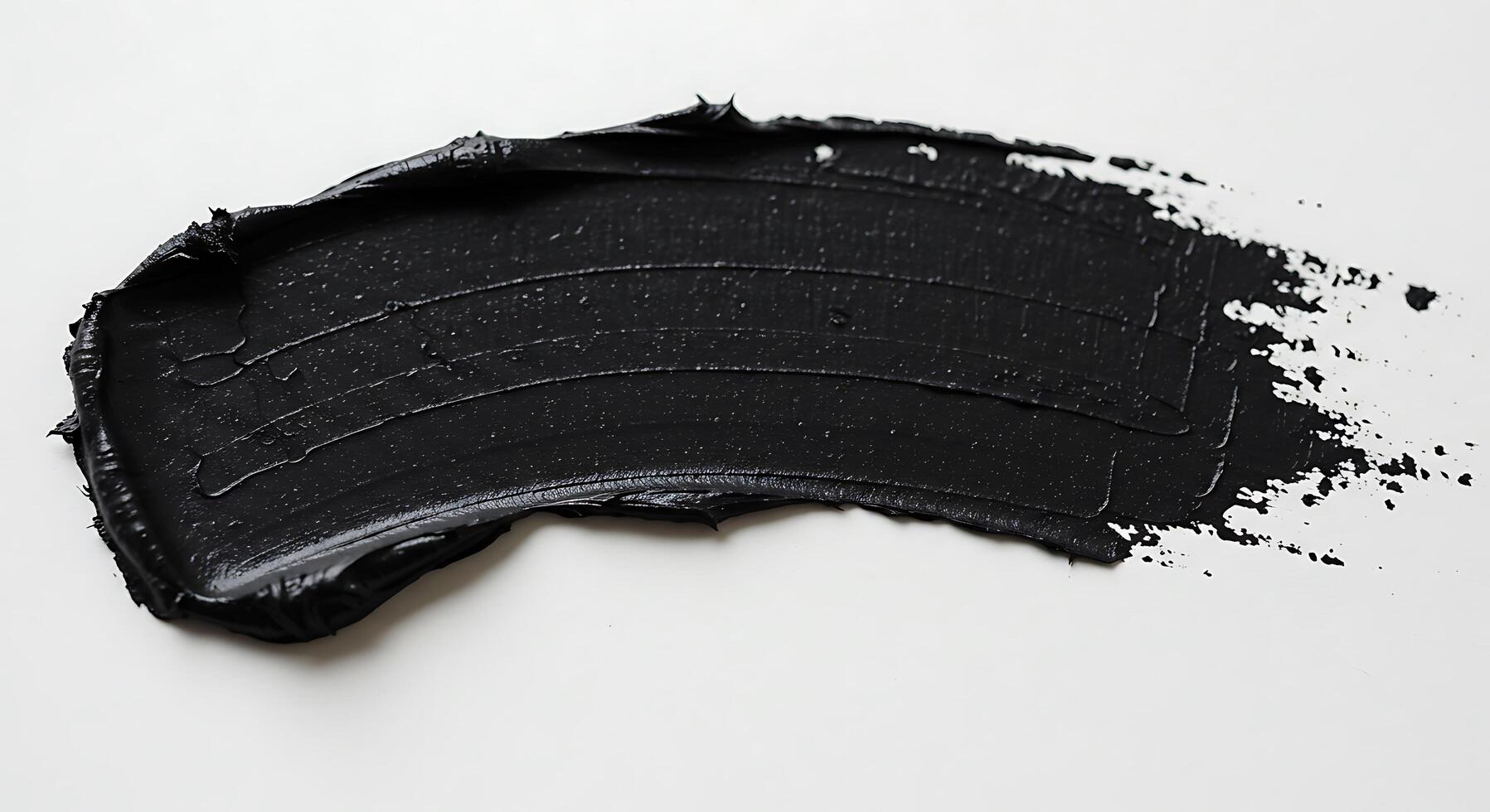 A black paint splatter on a white surface photo
