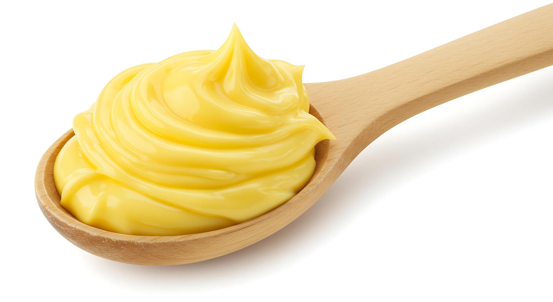 A wooden spoon with yellow butter on it photo
