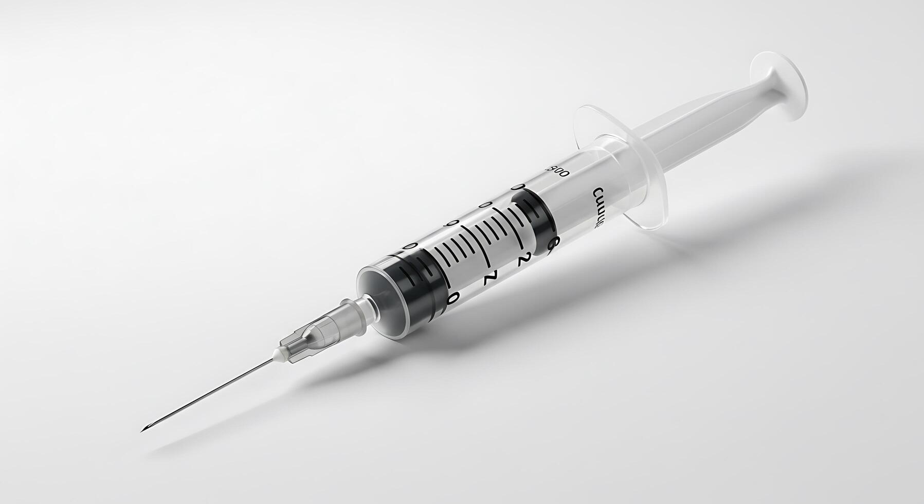 A syringe with a needle on a white surface photo