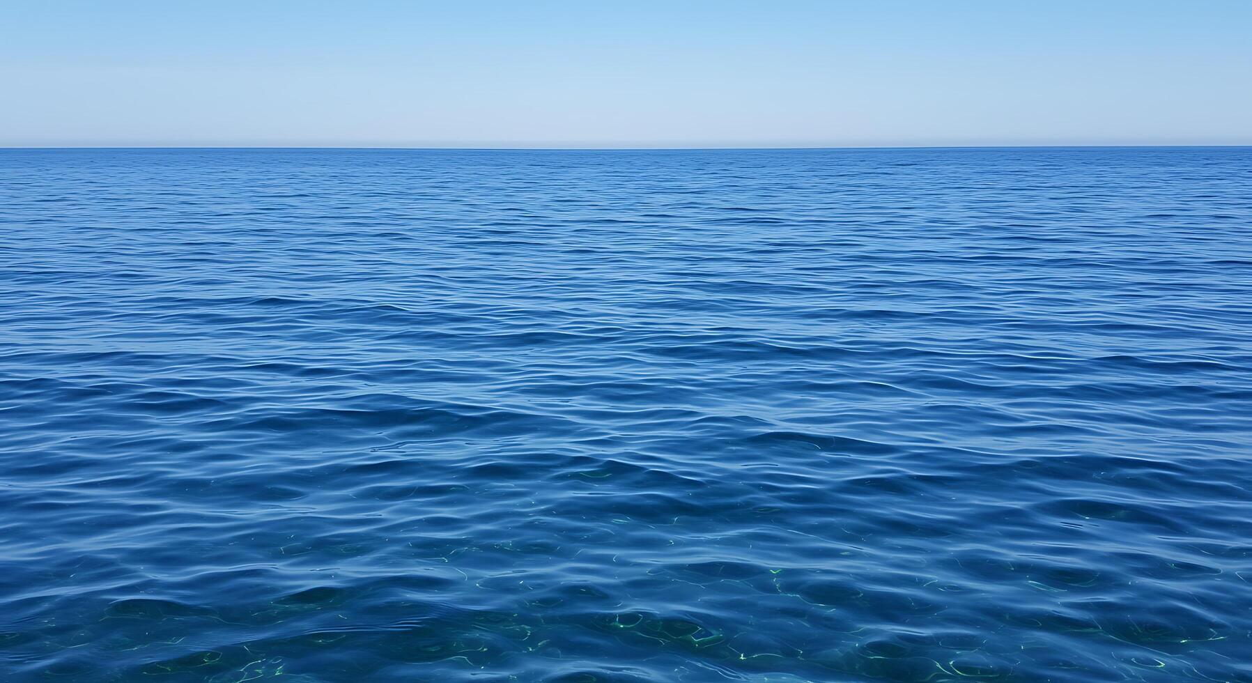 A large body of water with a blue sky photo