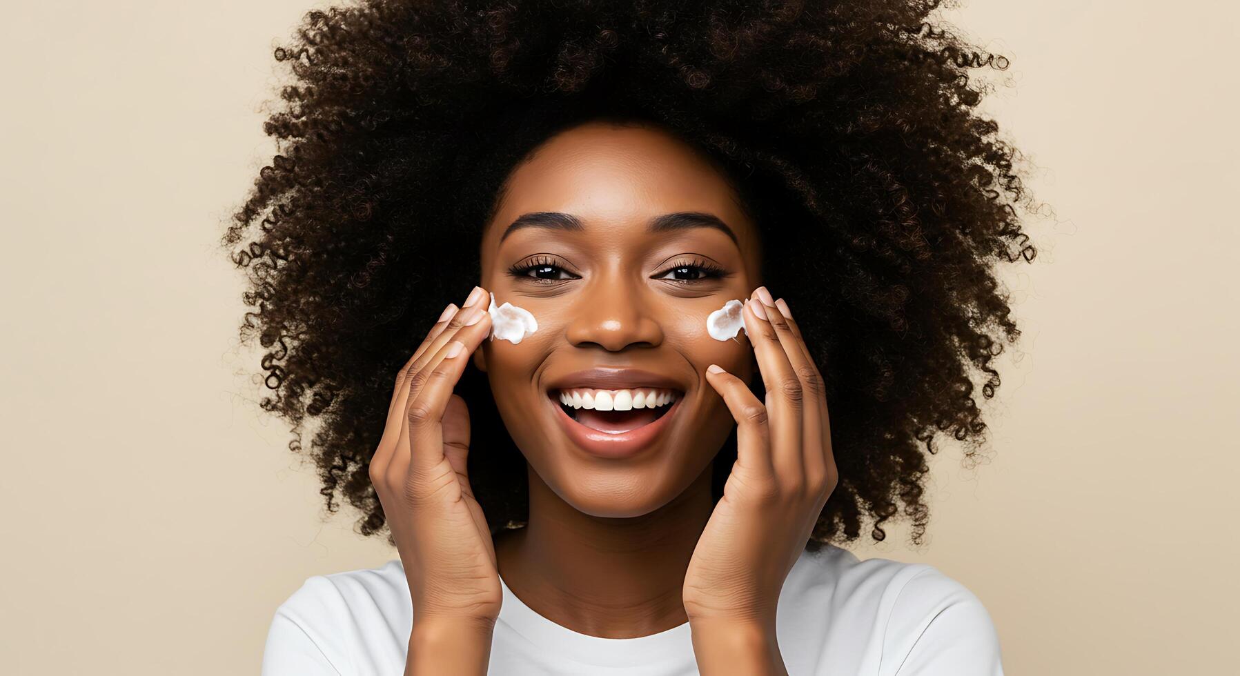 A woman with an afro hair is smiling and holding up a facial cream photo