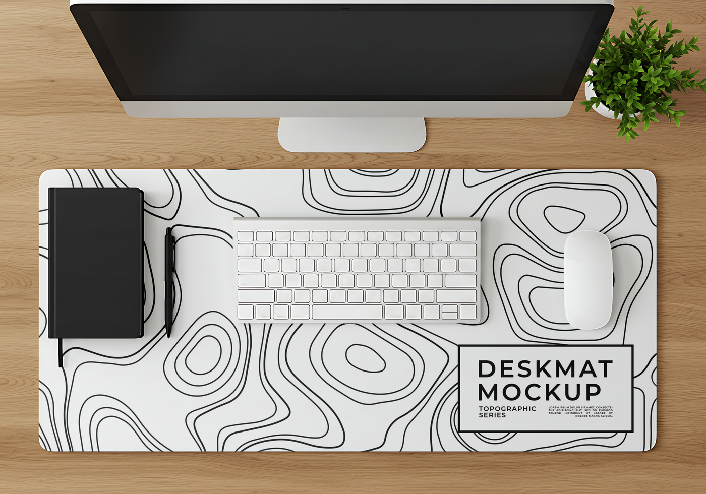 A minimalist desk setup featuring a topographic desk mat computer keyboard mouse and notebook psd