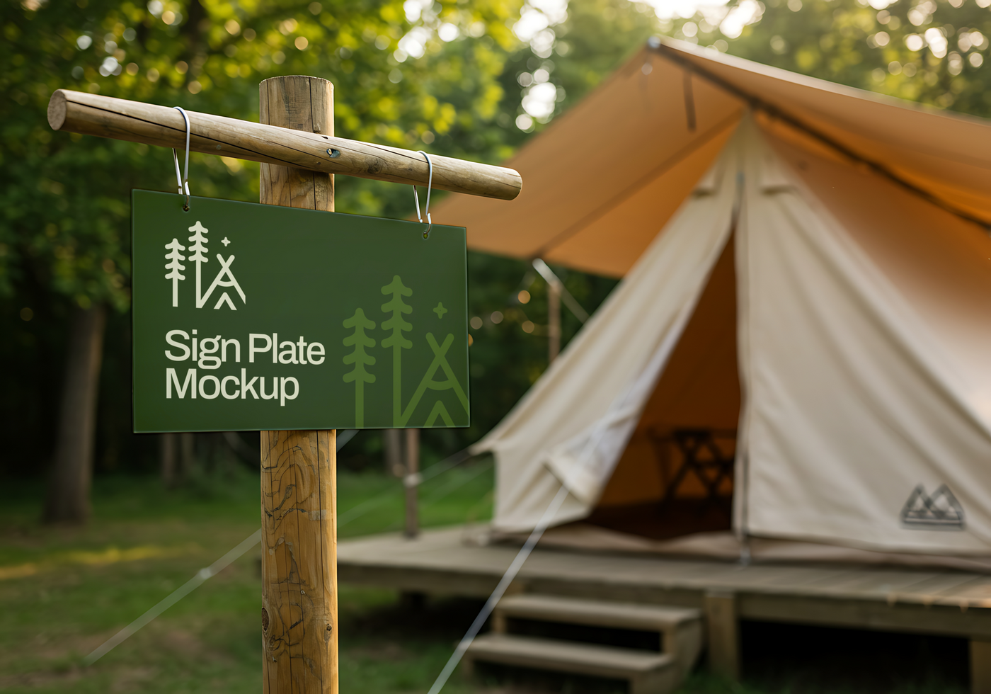 A rustic green sign plate mockup hangs near a canvas tent in a wooded area psd