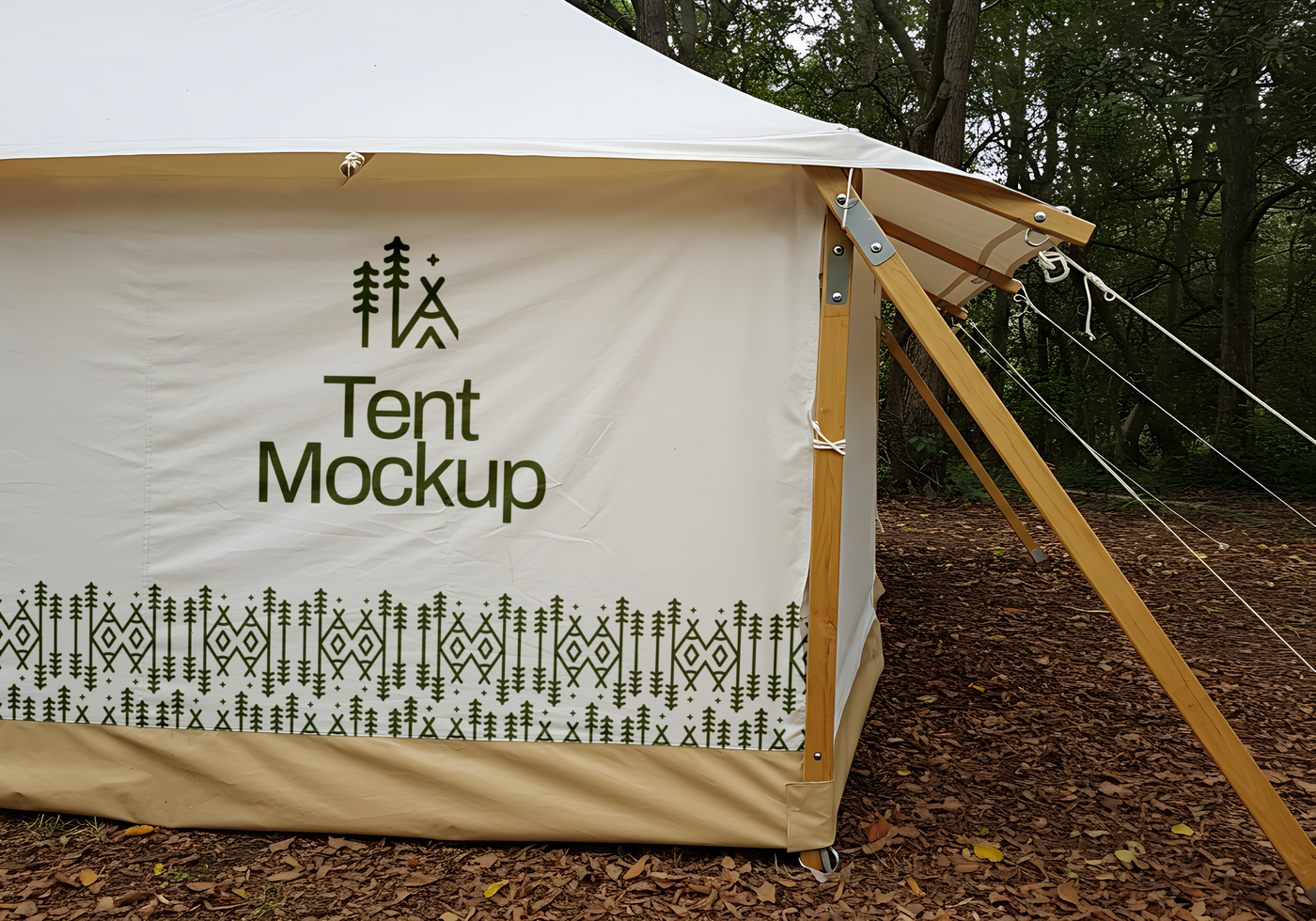 A canvas tent mockup with a forest themed design sits in a wooded area psd
