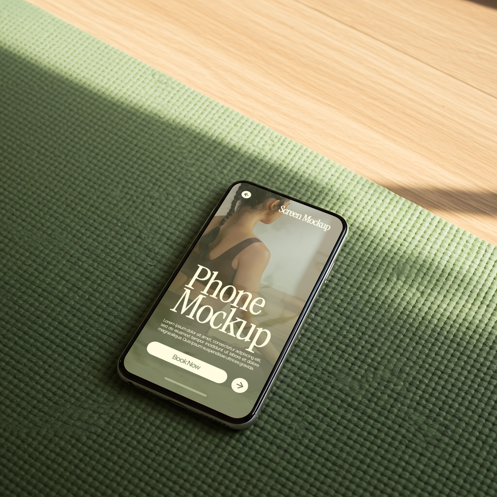 A smartphone displaying a phone mockup rests on a yoga mat psd