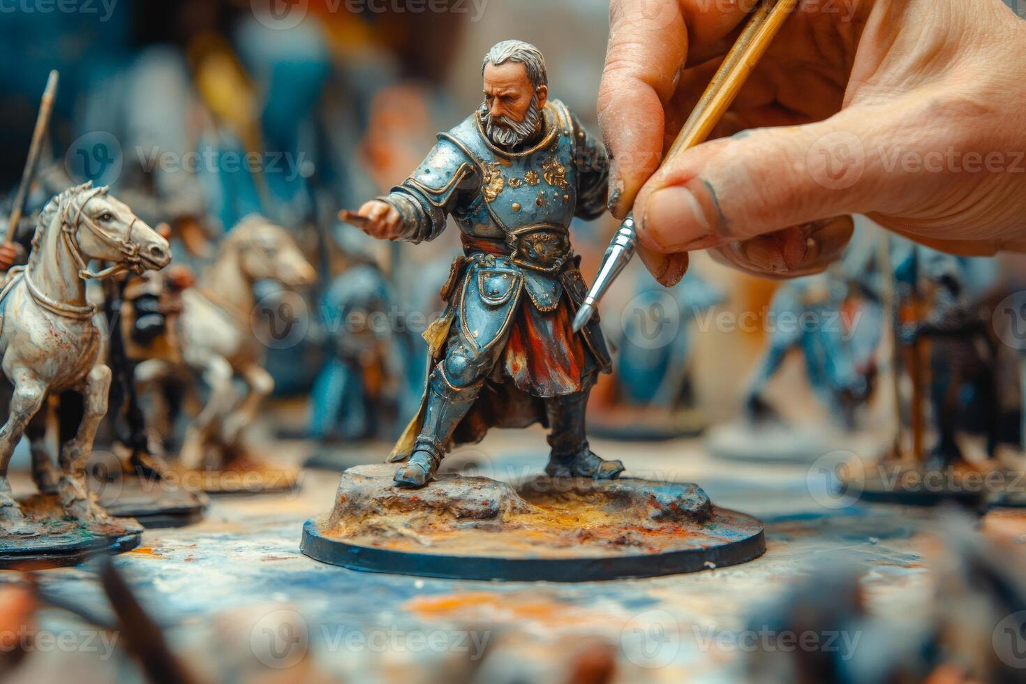 Artist painting fantasy miniature of medieval knight photo
