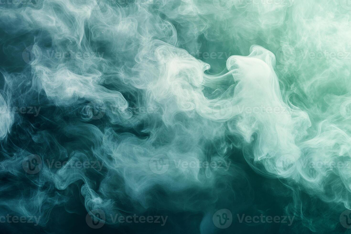Teal and white smoke creating abstract shapes on dark background photo