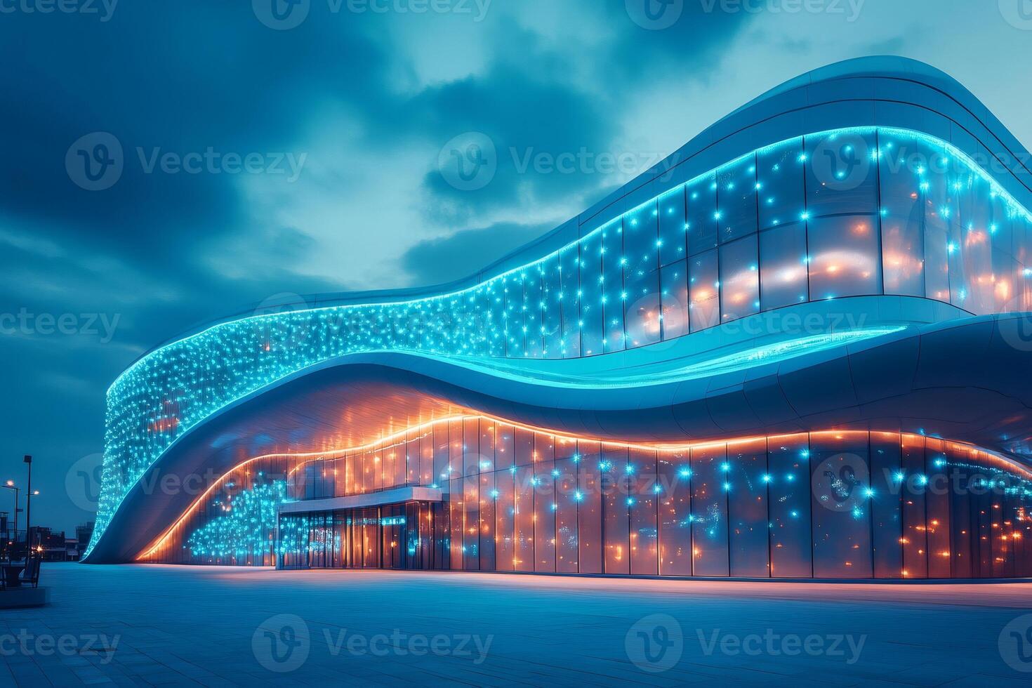 Futuristic wavy building shining at dusk with blue and orange lights photo