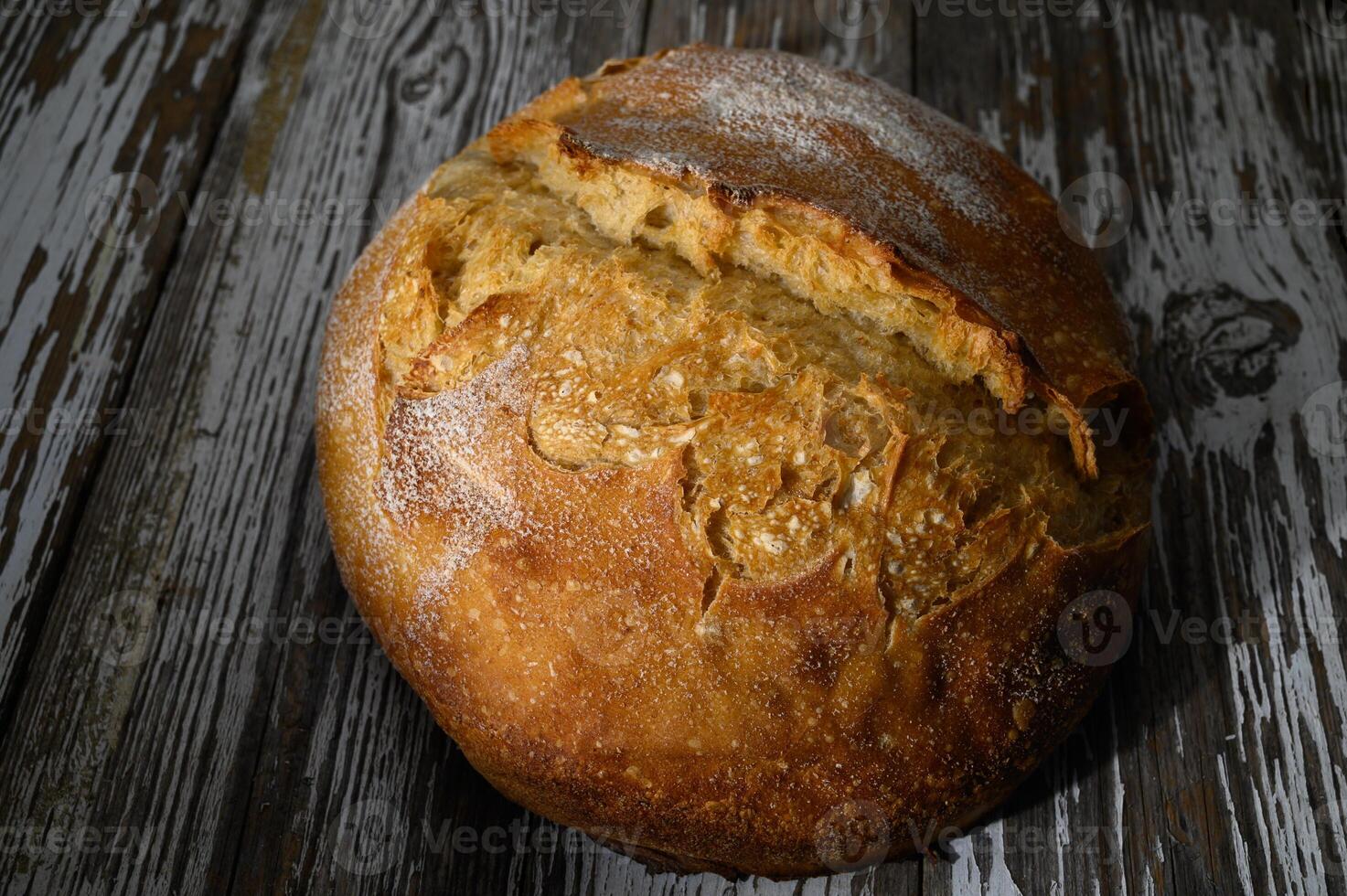 Freshly baked artisan bread resting on rustic wooden a crusty golden exterior photo