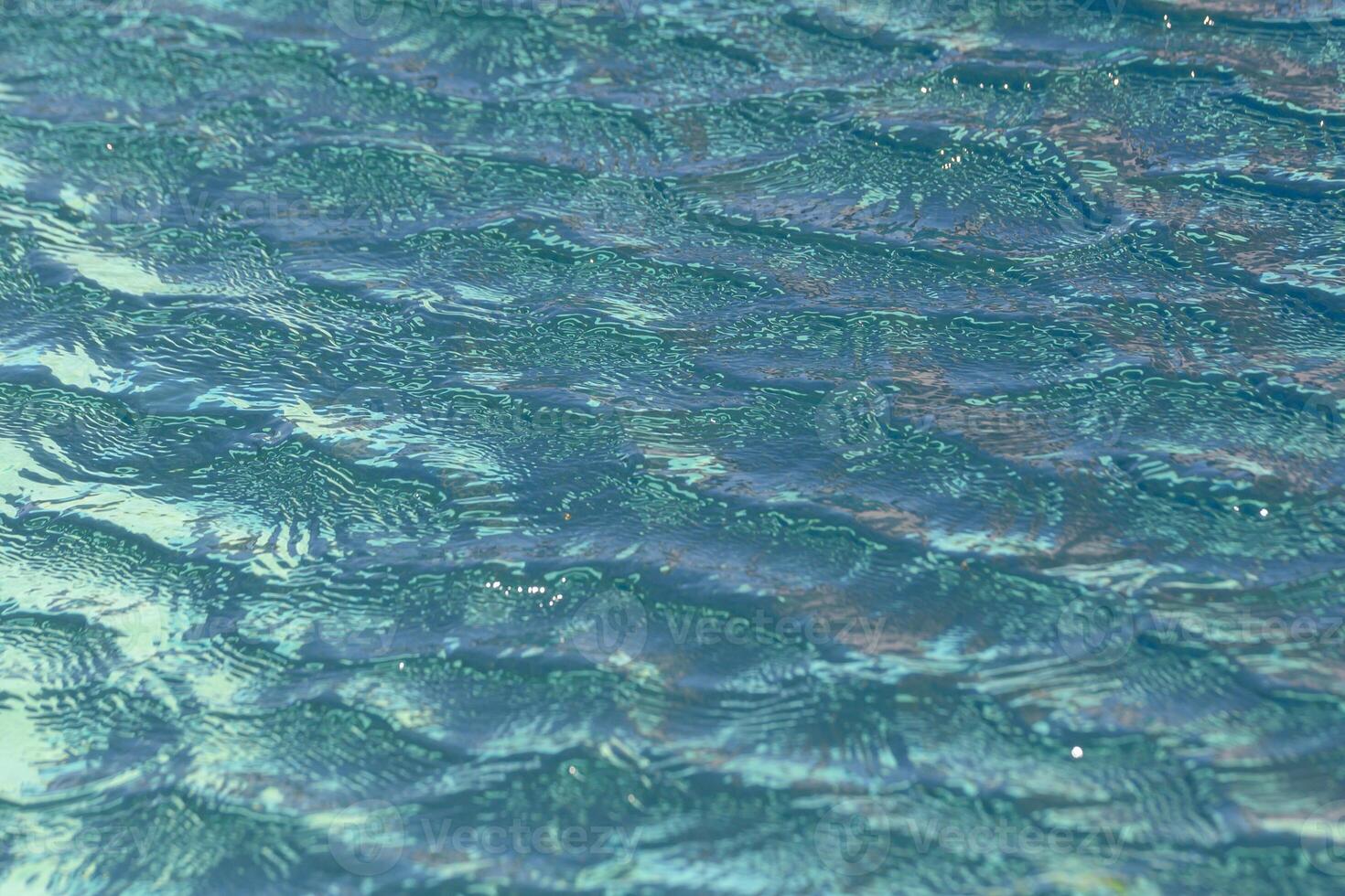 Rippling waves dance under the bright afternoon sun creating a soothing aquatic canvas photo