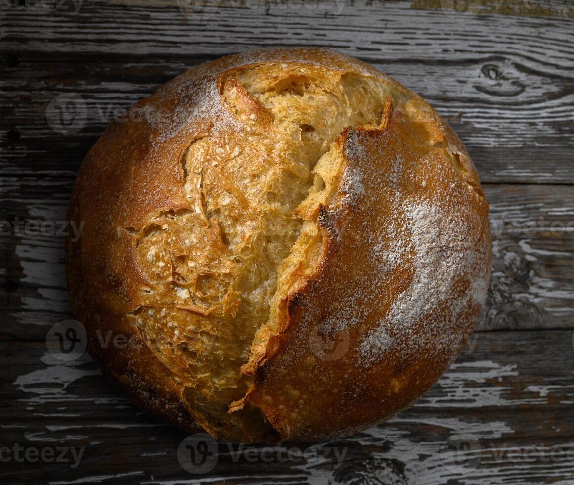 Freshly baked round loaf resting on rustic wooden table ready delightful meal photo