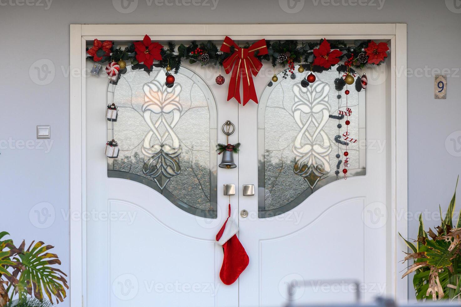 Festive holiday door adorned with decorations and a red stocking inviting warmth and cheer 1 photo