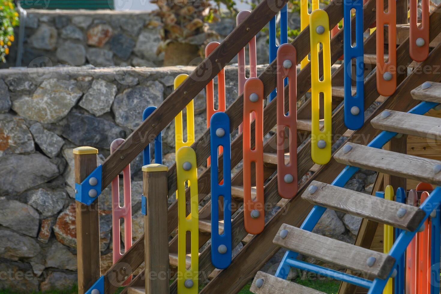Colorful climbing structure invites joyful playtime at a sunny outdoor playground photo