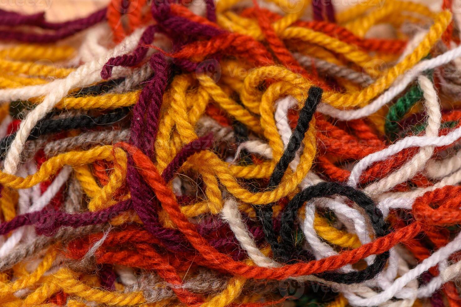 Detailed macro of multicolored yarn threads arranged for knitting. Great for crafting themes, DIY visuals, and textile blogs. photo