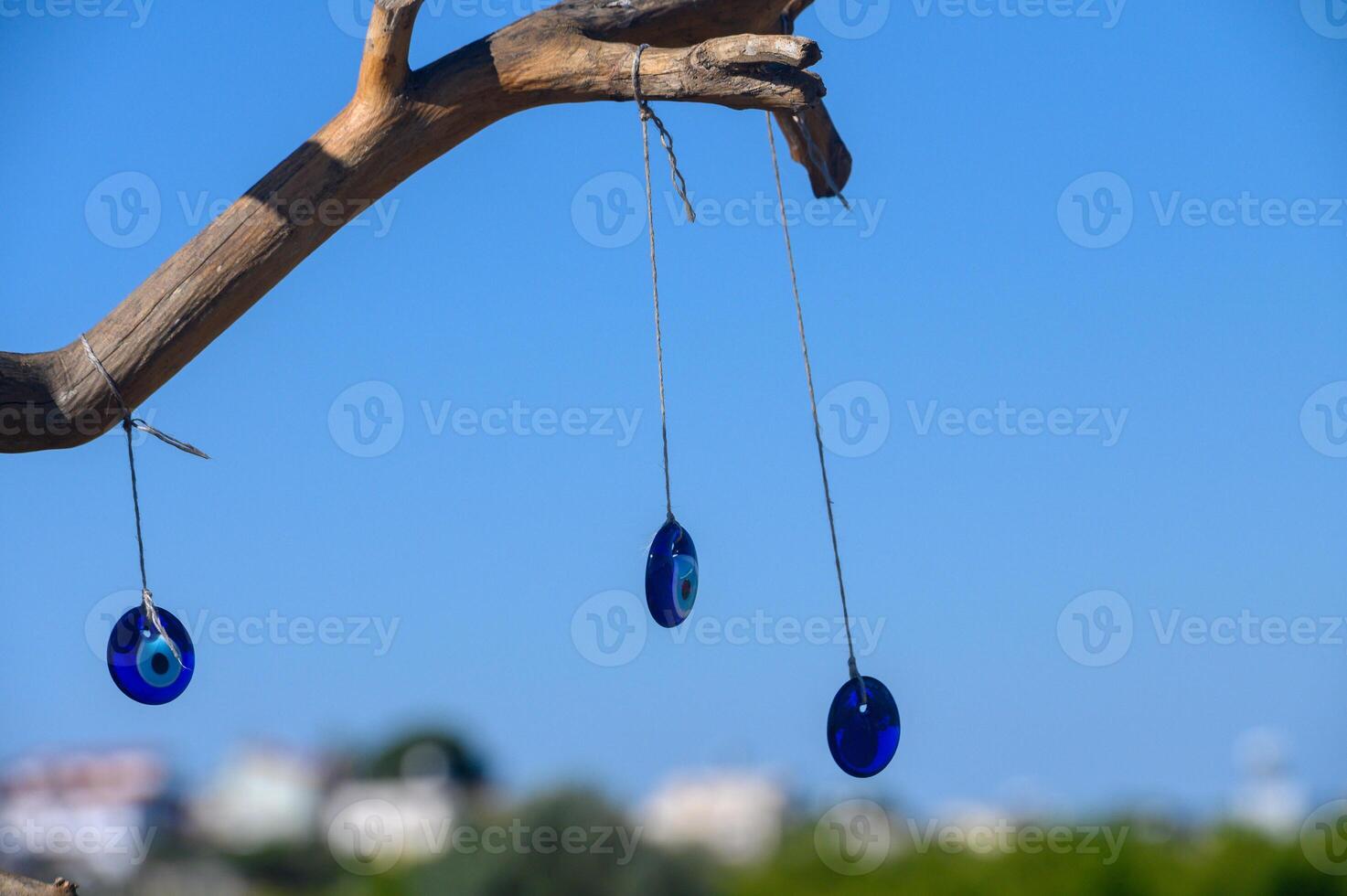 Strings of luck and protection sway gently in the breeze under a clear blue sky by the coast photo
