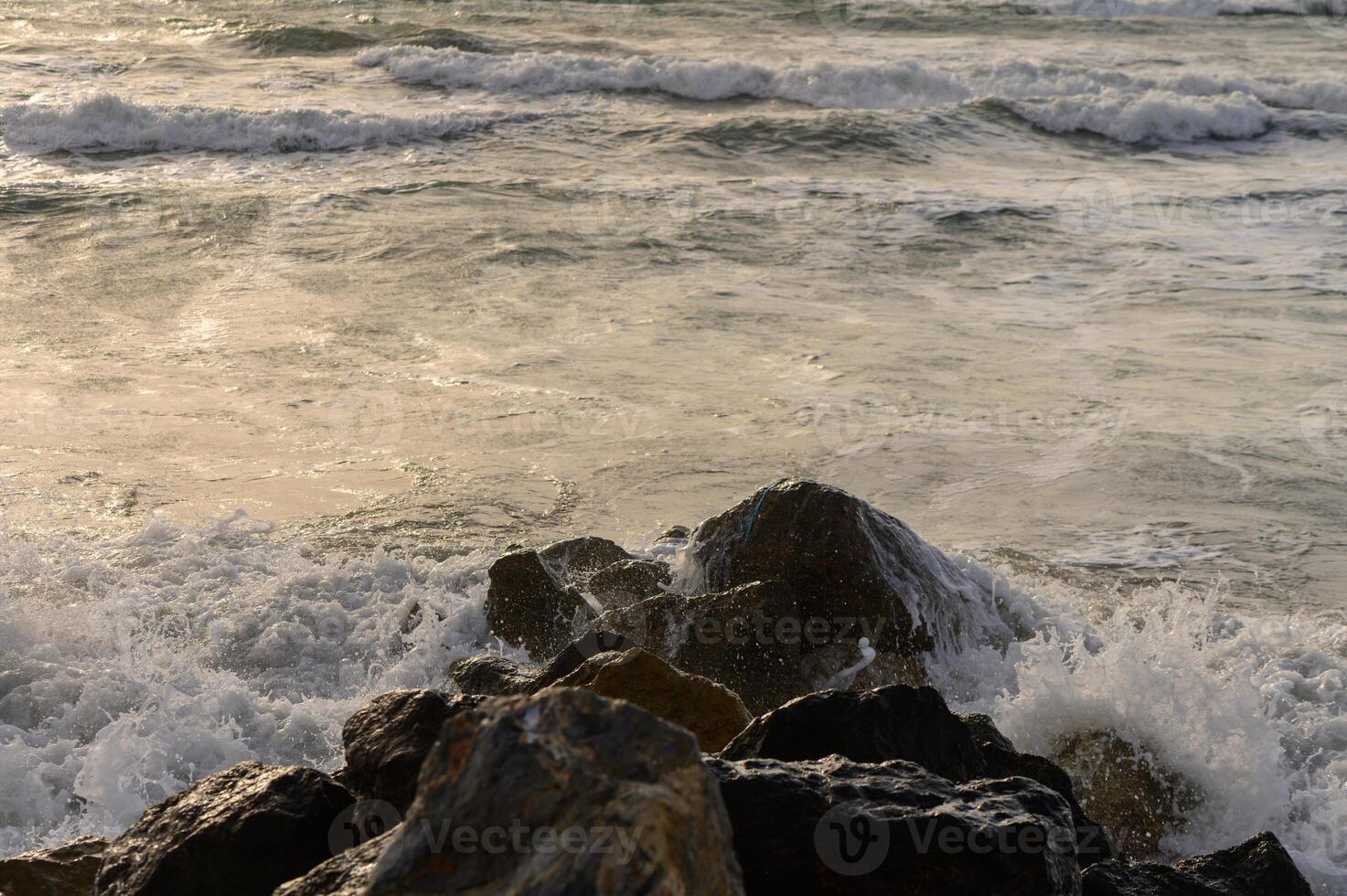 Close-up view of textured sea water and small waves breaking near the coast of Cyprus. Natural marine detail in Mediterranean environment. photo