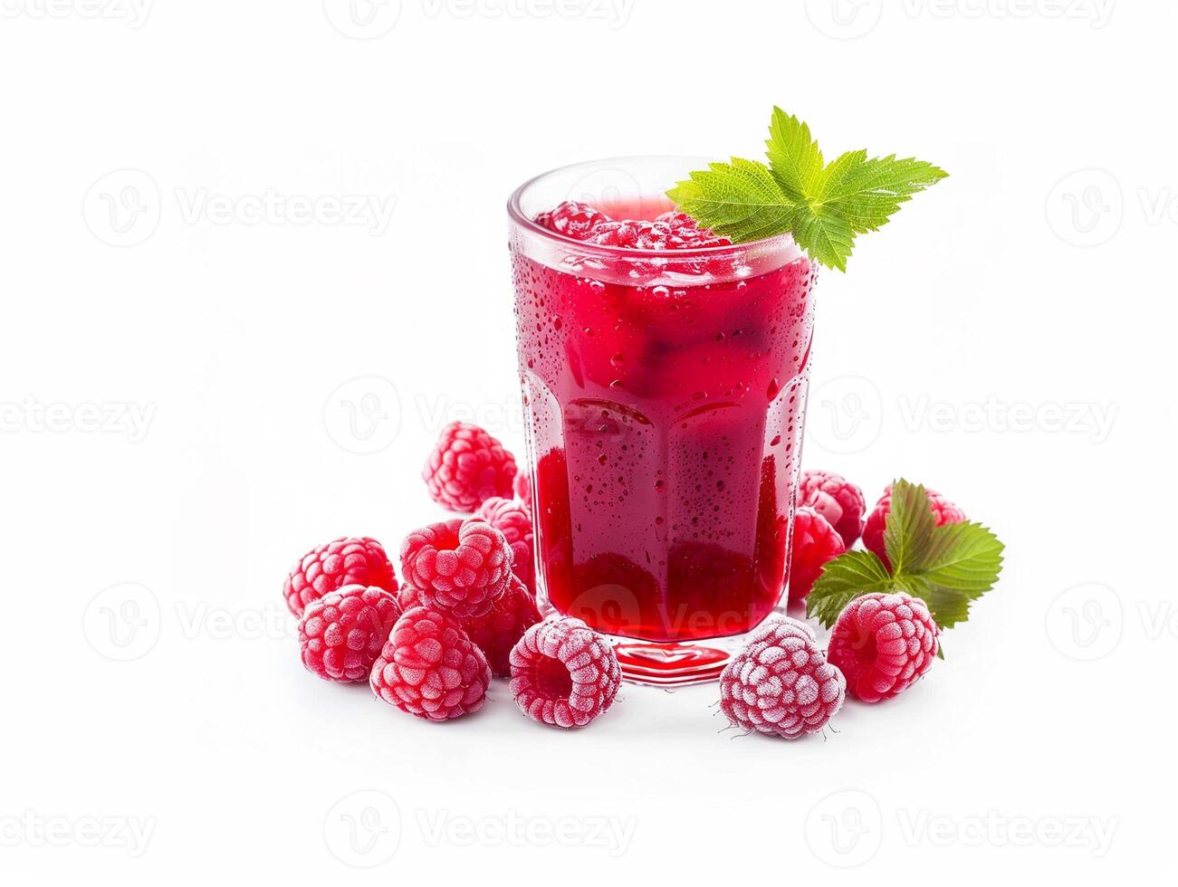 A glass of red raspberry juice with a sprig of mint on top photo