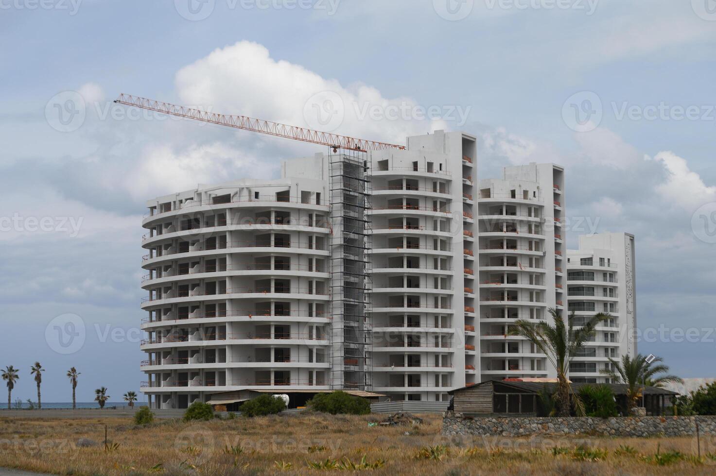 Construction of a modern residential building near the coastline at dusk in a serene tropical setting photo