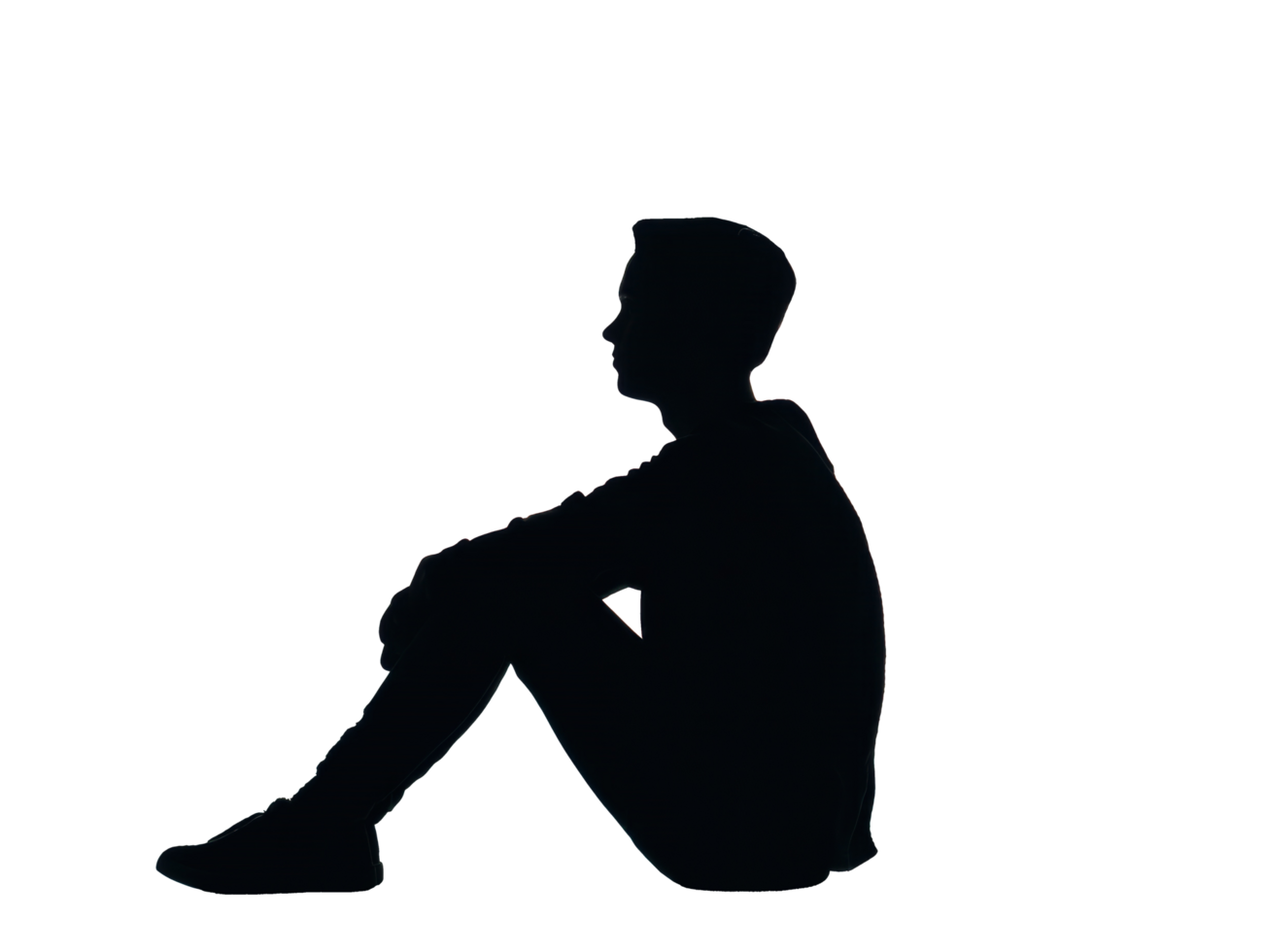 Silhouette of a lone person sitting pensively on the ground png
