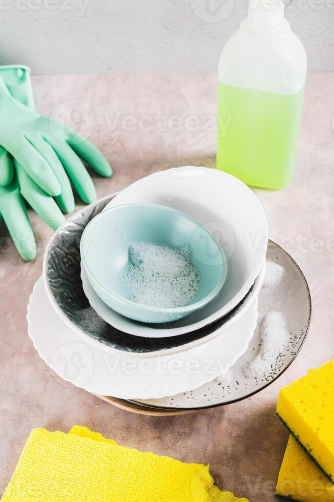Washing dirty dishes and items for washing on the table vertical view photo