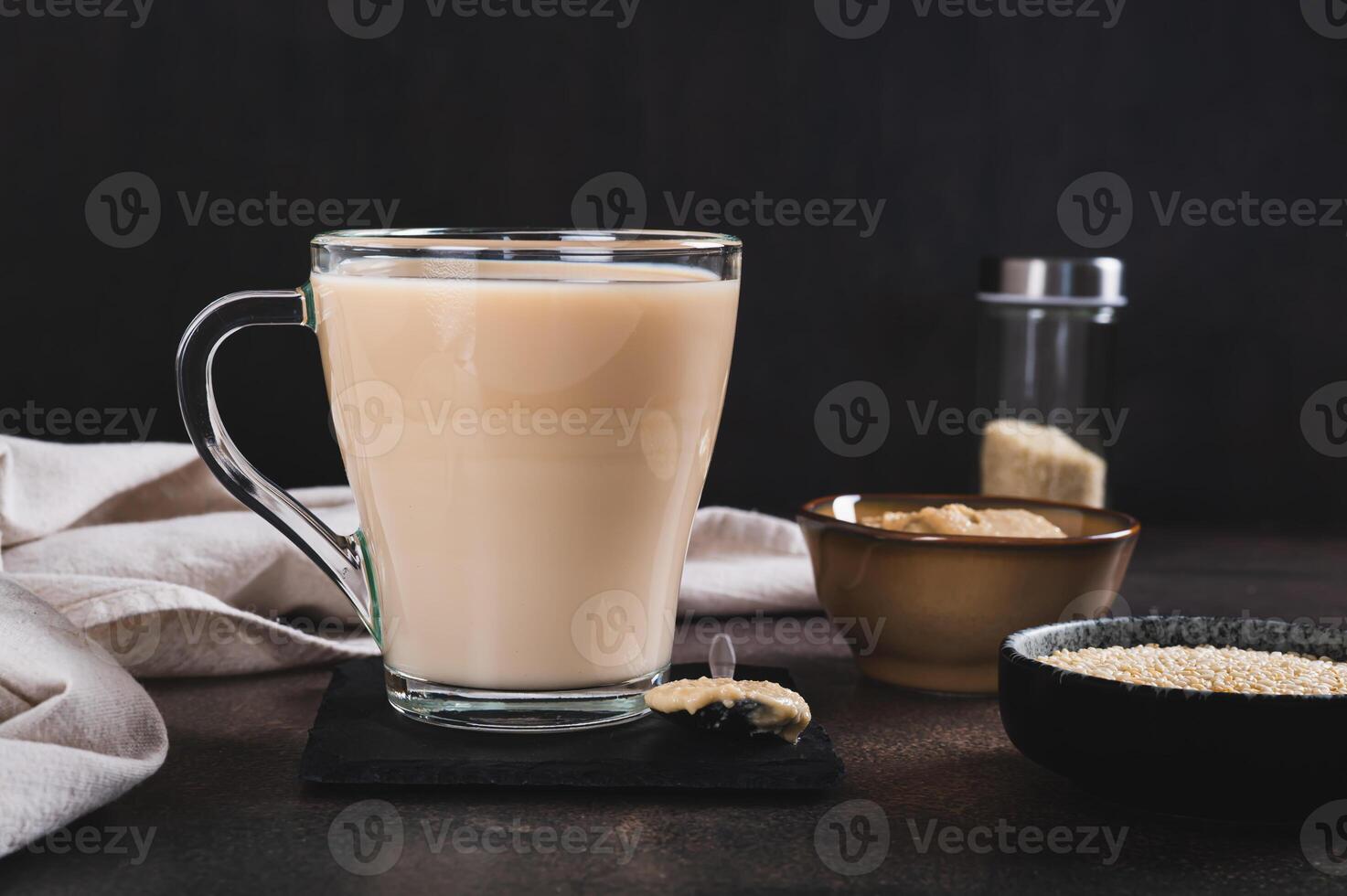 Tahini latte with sesame spread in a cup on the table photo