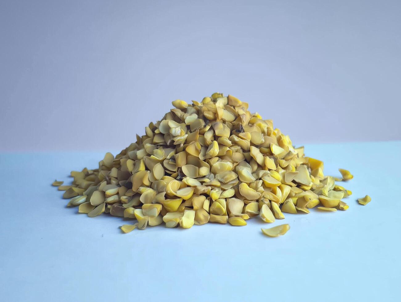 Pile of yellow nuts on a white table photo