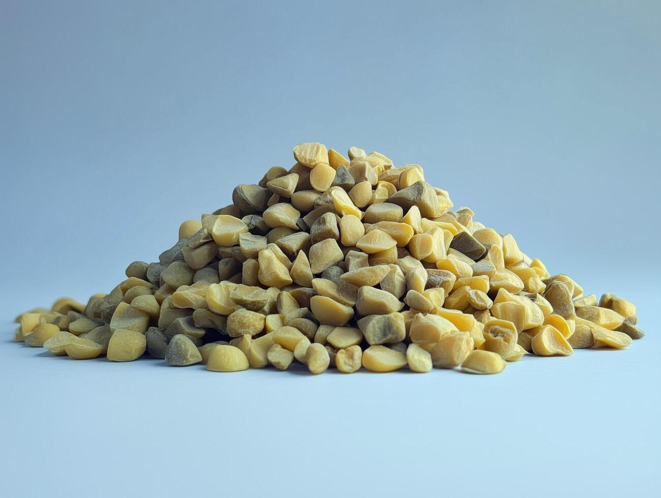 Pile of yellow scattered nuts on a white table photo