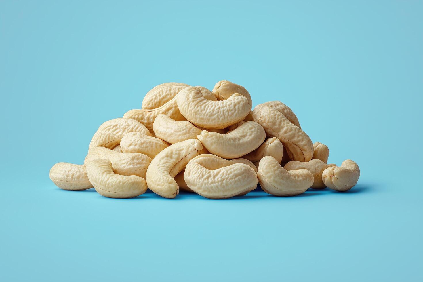 Pile of cashews on a blue background photo