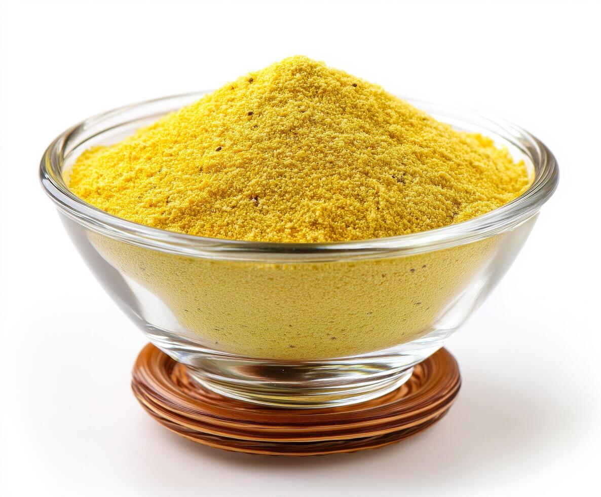 yellow powder like Mustard powder on glass bowl photo