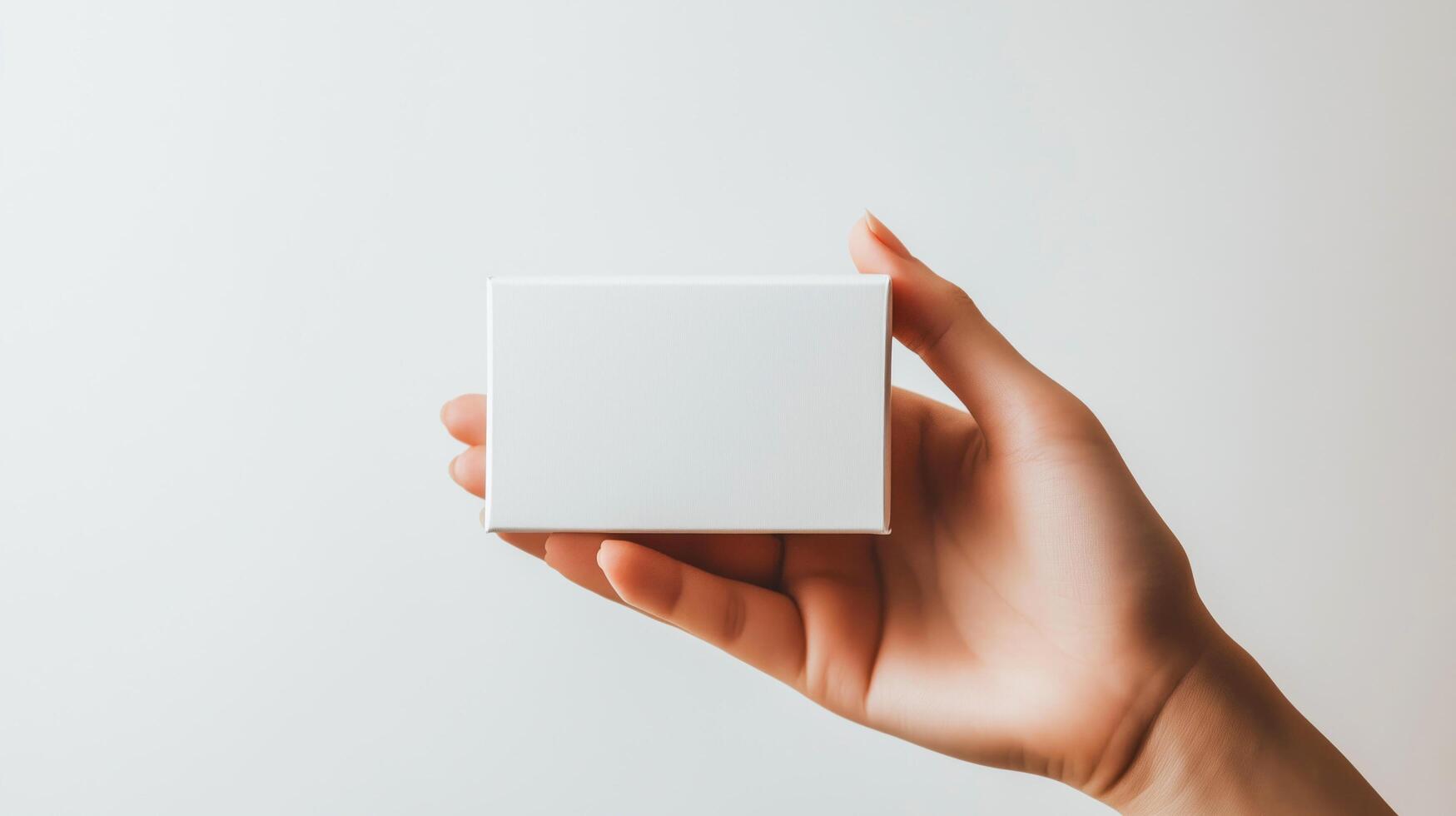 Empty white business card in hand, isolated. photo