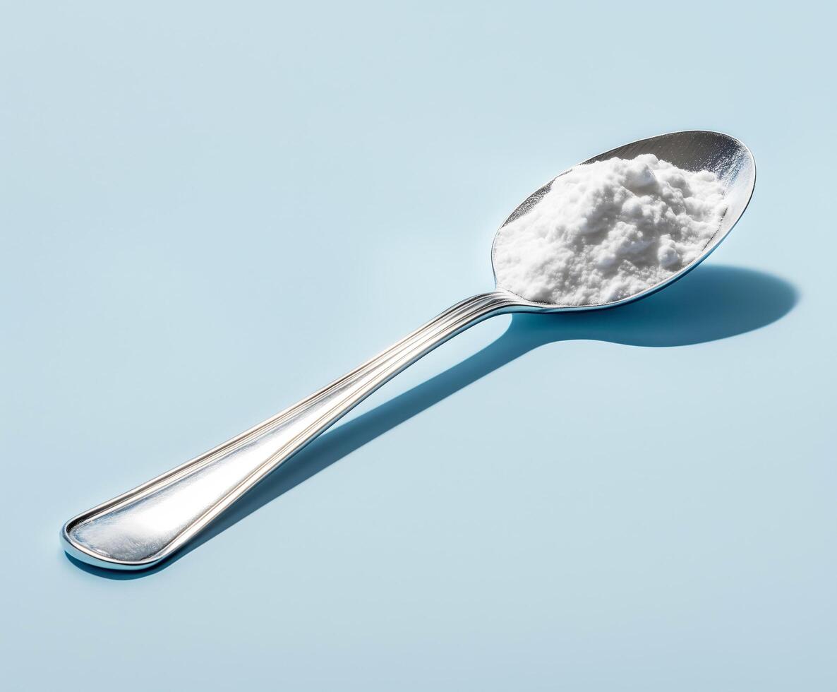 Spoon of a white powder on it photo