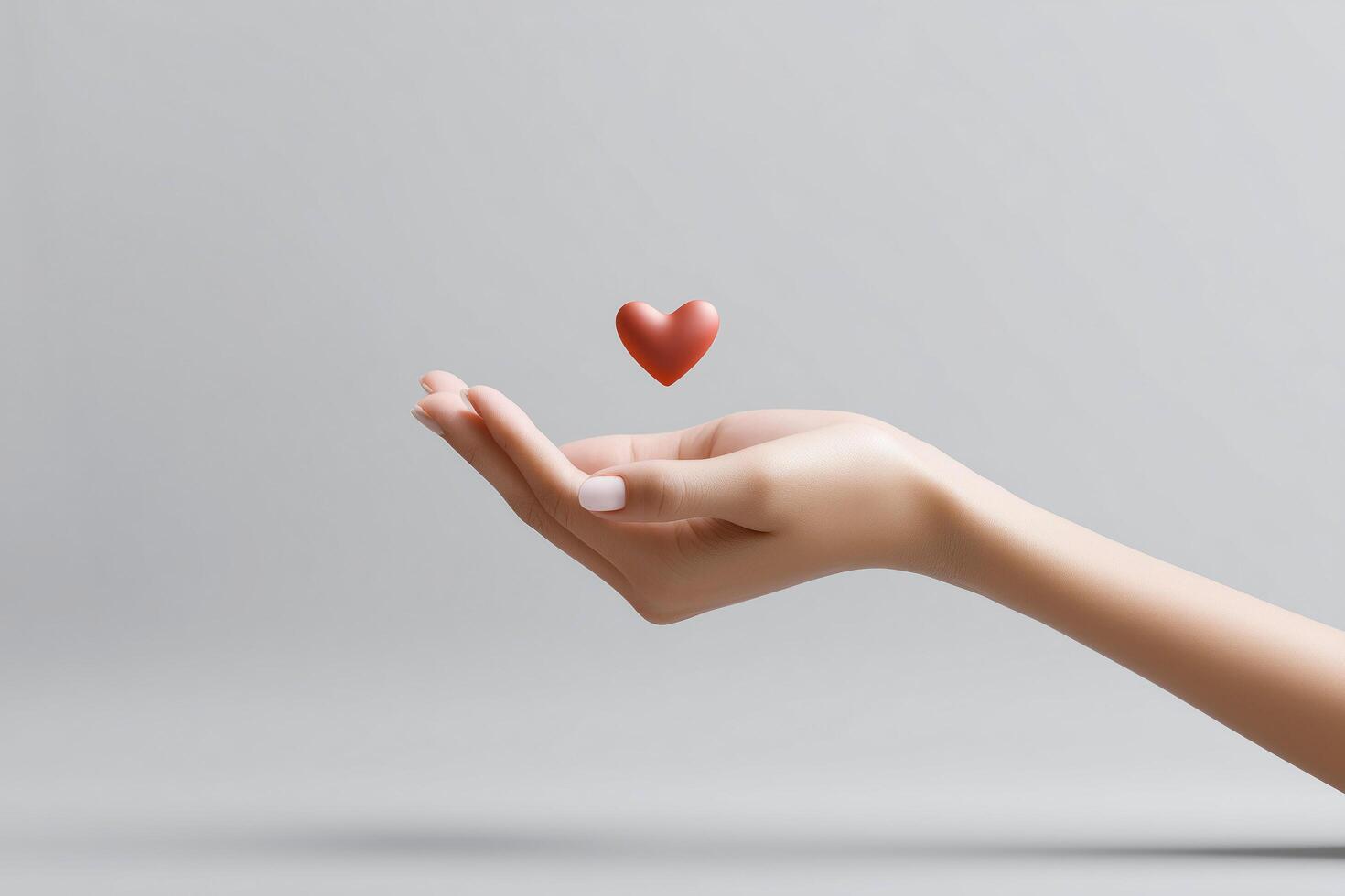 Open palm with floating heart symbol above it photo