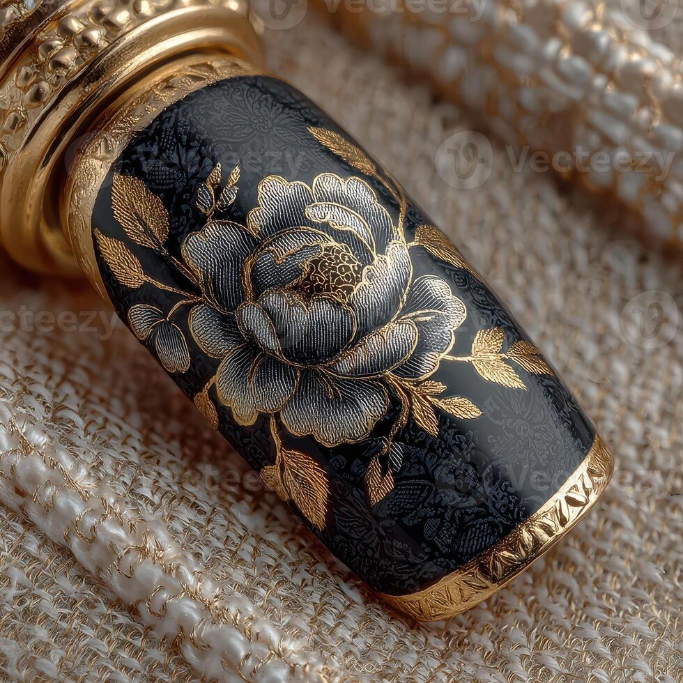 Intricate black and gold floral design on a decorative object with fine detailing photo