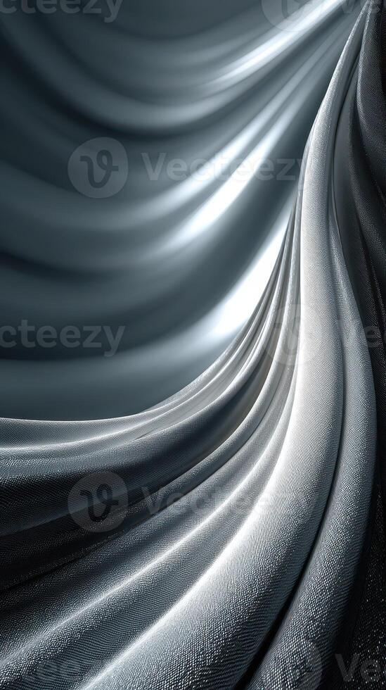 Elegant flowing fabric illuminated by soft light creates a mesmerizing wave pattern in shades of gray and silver photo
