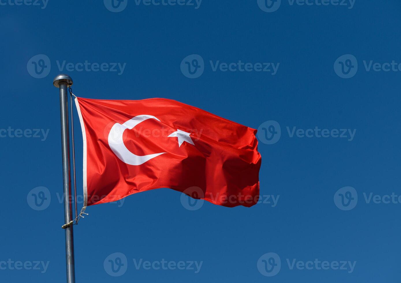 Waving proudly against the clear blue sky, a Turkish flag symbolizes national identity and unity at a public square photo