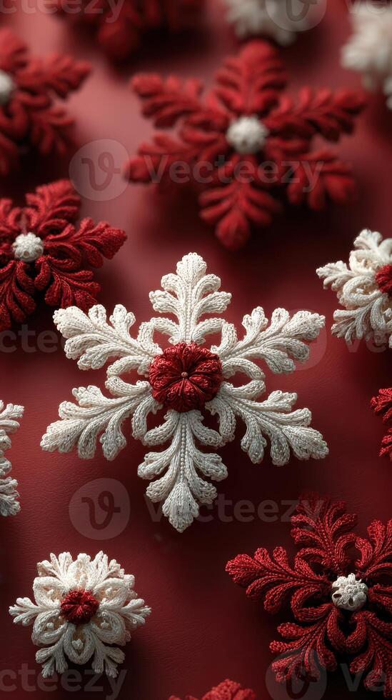 Decorative red and white snowflakes made from thread placed on a vibrant red background for winter celebrations photo
