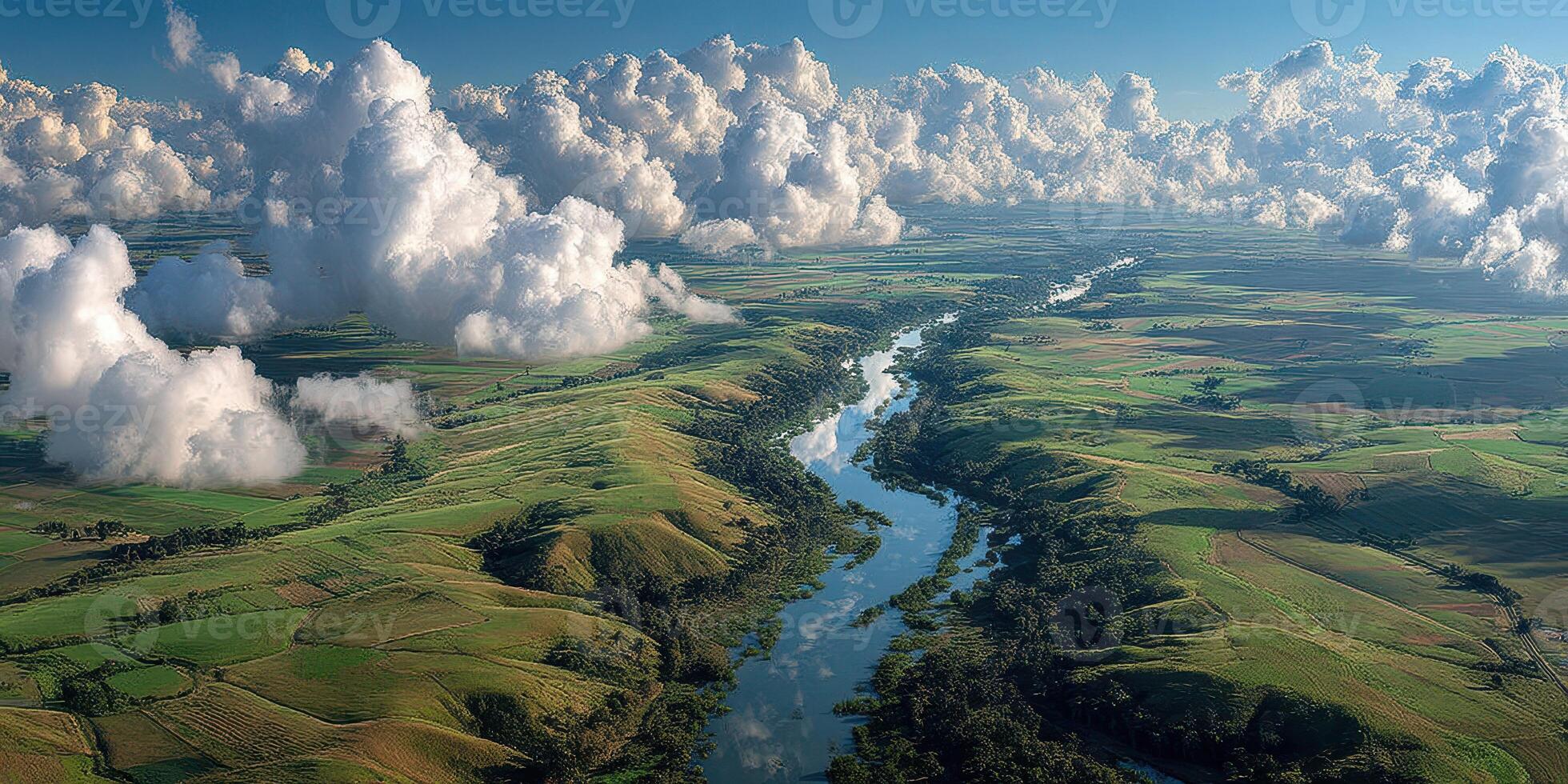 Vast green landscape with winding river under a blue sky filled with fluffy clouds during a sunny day photo