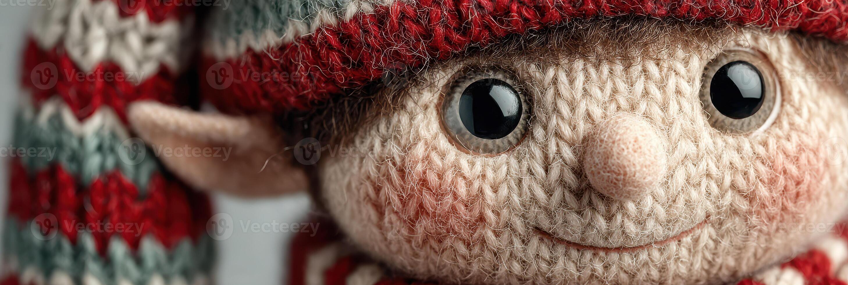 Cute knitted elf toy with striped hat and cheerful expression displayed indoors in soft lighting during the holiday season photo